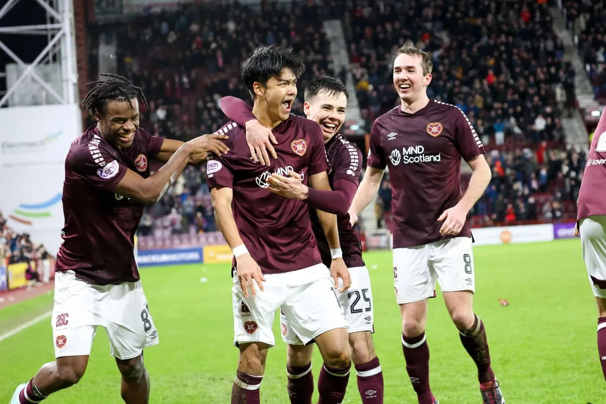Beau Reus saved two penalties as Hearts overcame Rapid Vienna to reach the Conference League group phase